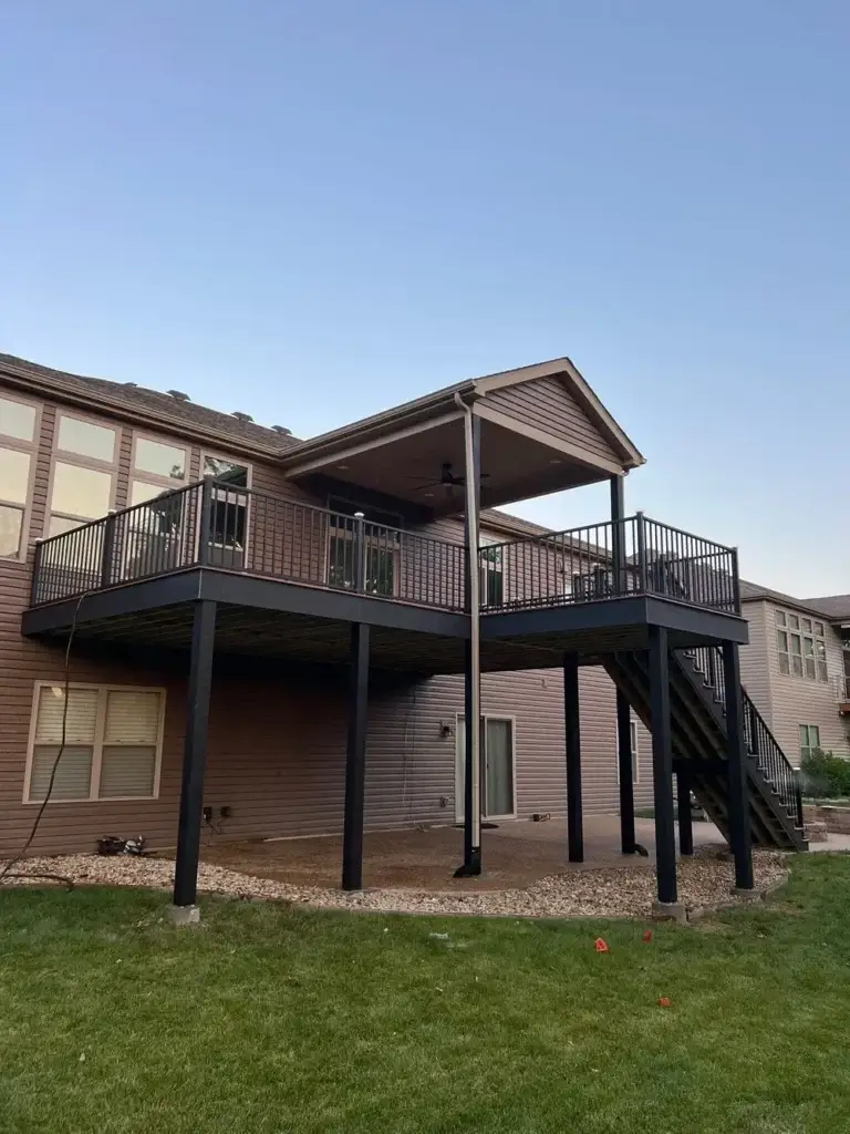 Elevated backyard deck with covered patio and stairs on a home in St. Louis, MO