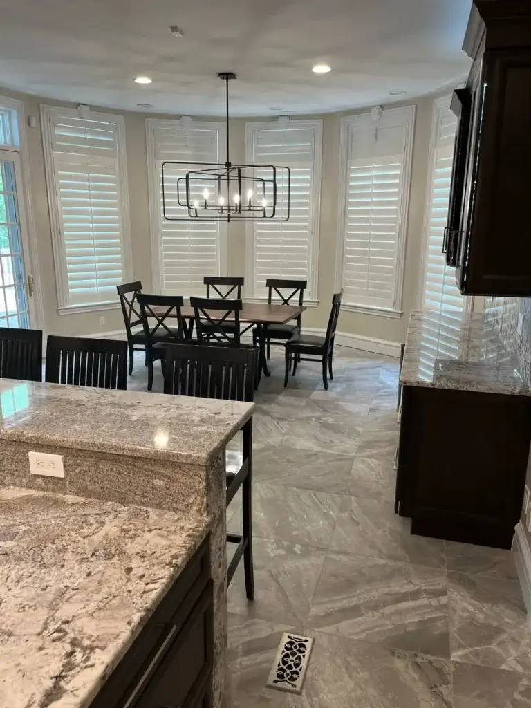 Bright kitchen and dining area with granite counters and large windows in St. Louis, MO