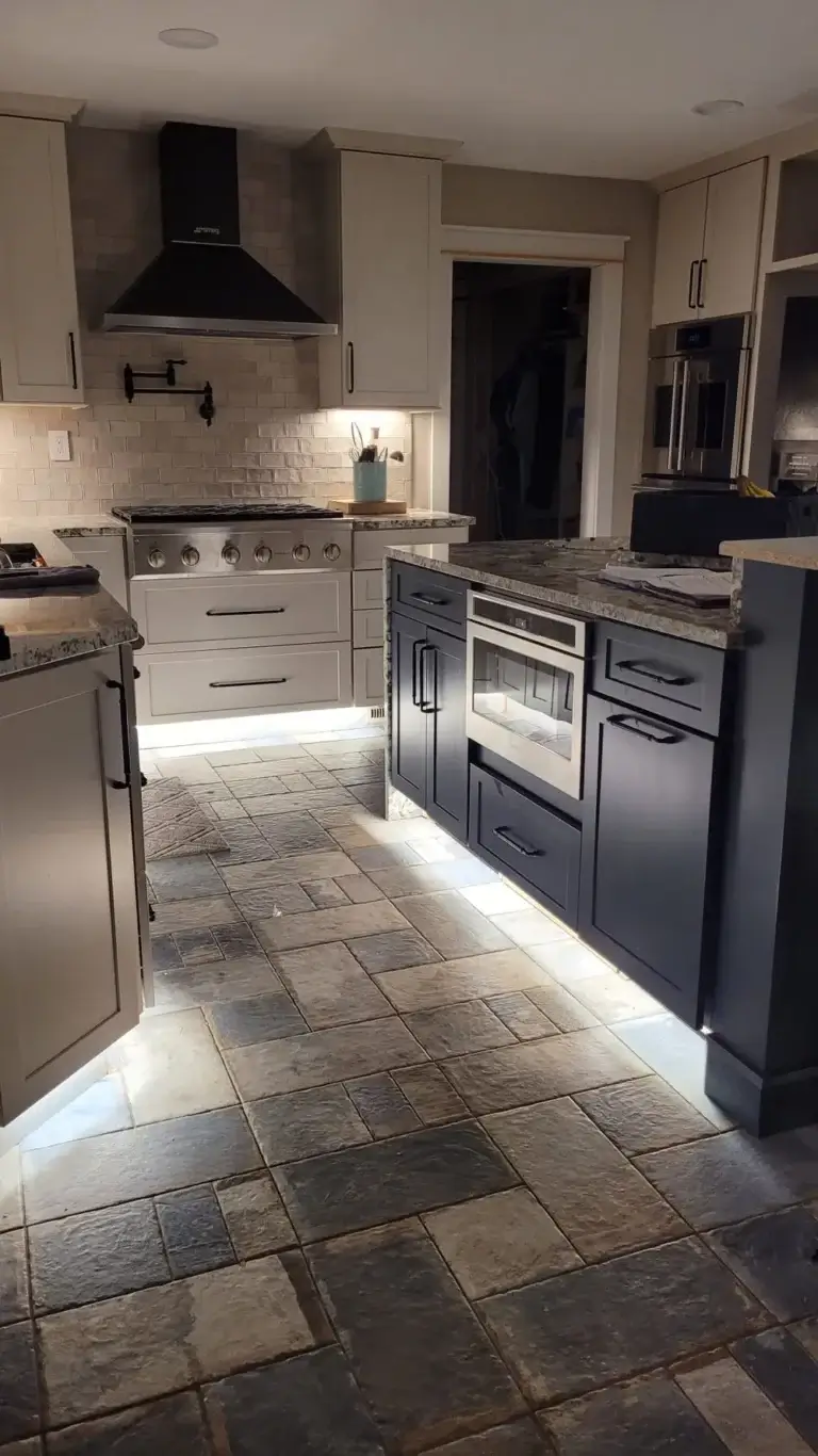 Modern kitchen remodel with stone flooring and under-cabinet lighting in St. Louis, MO